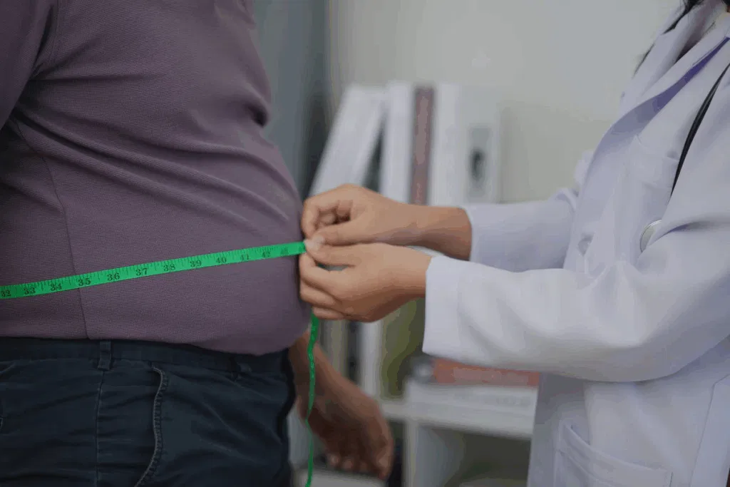 Clinician measuring an employee's waist circumference during a workplace health check