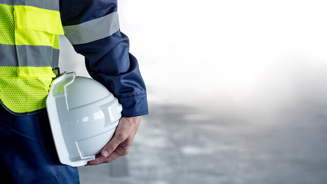 Worker lifting a heavy box in a warehouse — manual handling injury risk