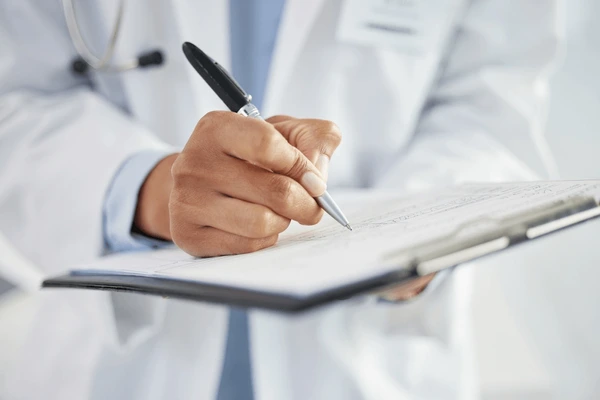 Occupational health clinician reviewing a report with an HR professional